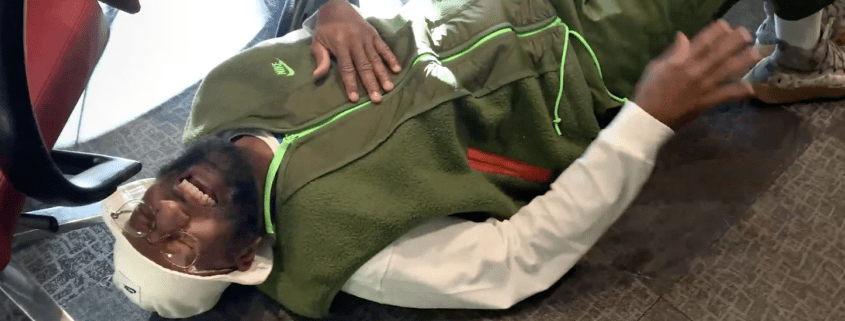 Man lying on floor, smiling and relaxed.